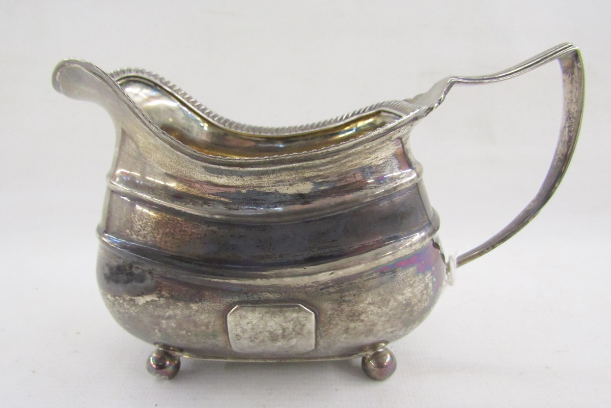 George III silver pouring jug, with reeded border, raised on four bun feet, hallmarked London - Image 3 of 5