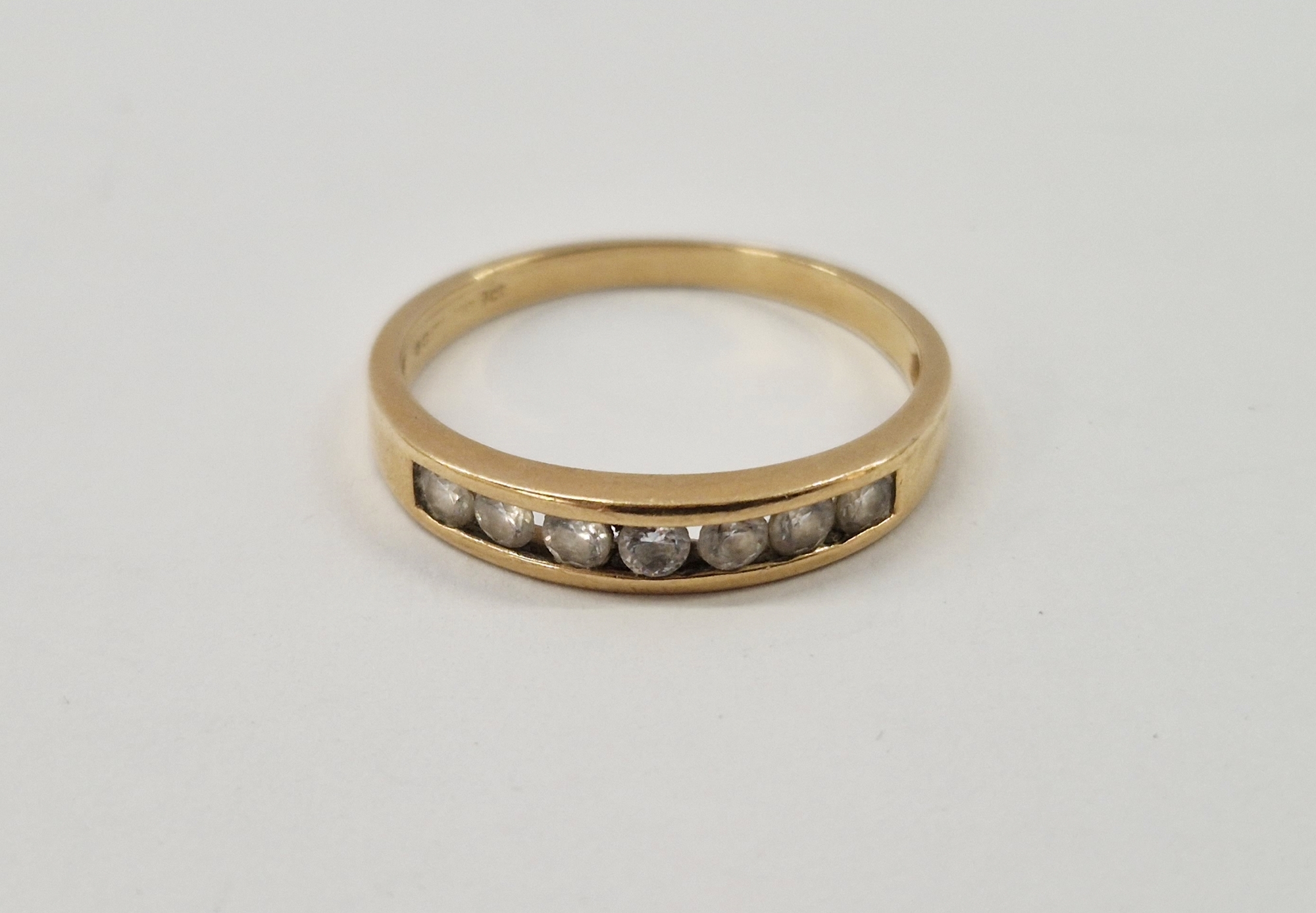 9ct gold and seven-stone diamond half-hoop ring size O, 1.7g gross approx.