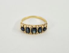 18ct gold, sapphire and diamond dress ring set five blue stones interspersed with small diamonds