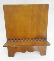 Antique fruitwood book rest with inscription to reverse dated 1882, on scroll bracket feet, 38cm x