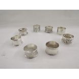 Collection of eight silver napkin rings, of varying designs including pierced and engine turned,