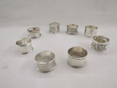 Collection of eight silver napkin rings, of varying designs including pierced and engine turned,