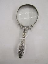 Late 19th/early 20th century silver magnifying glass, with embossed floral motifs adorning the