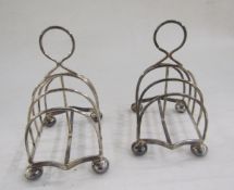 Pair of Edwardian silver four slice toast racks, raised on bun feet, hallmarked Chester 1907, by