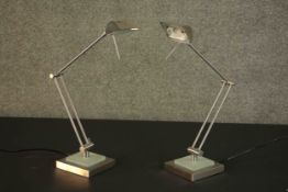 A pair of contemporary nickel plated adjustable desk lamps, on square bases. H.50cm. (each)
