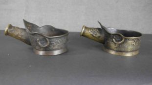 Two Chinese bronze silk irons with relief dragon design. H.10 W.14 D.21cm.