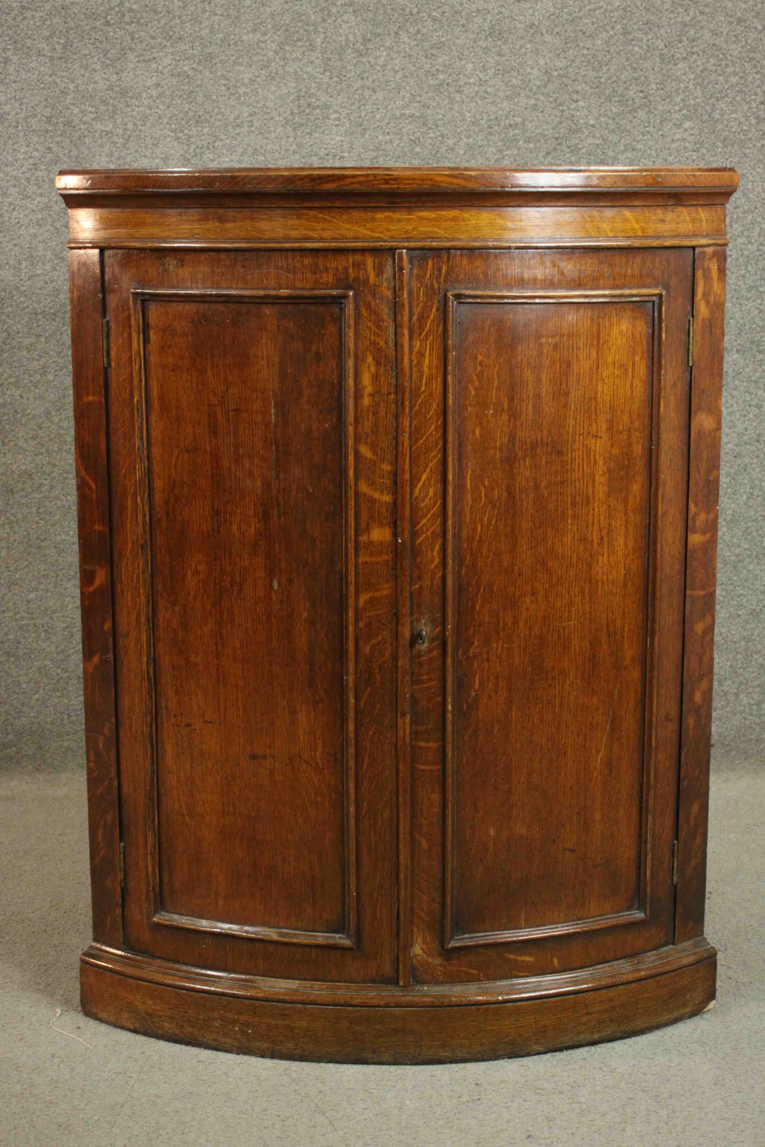 A 19th century oak bow fronted corner cabinet, with two doors opening to reveal a shelf on a - Image 3 of 7