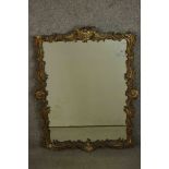 A 19th century Rococo revival mirror, the carved wood and gesso frame adorned with C and S
