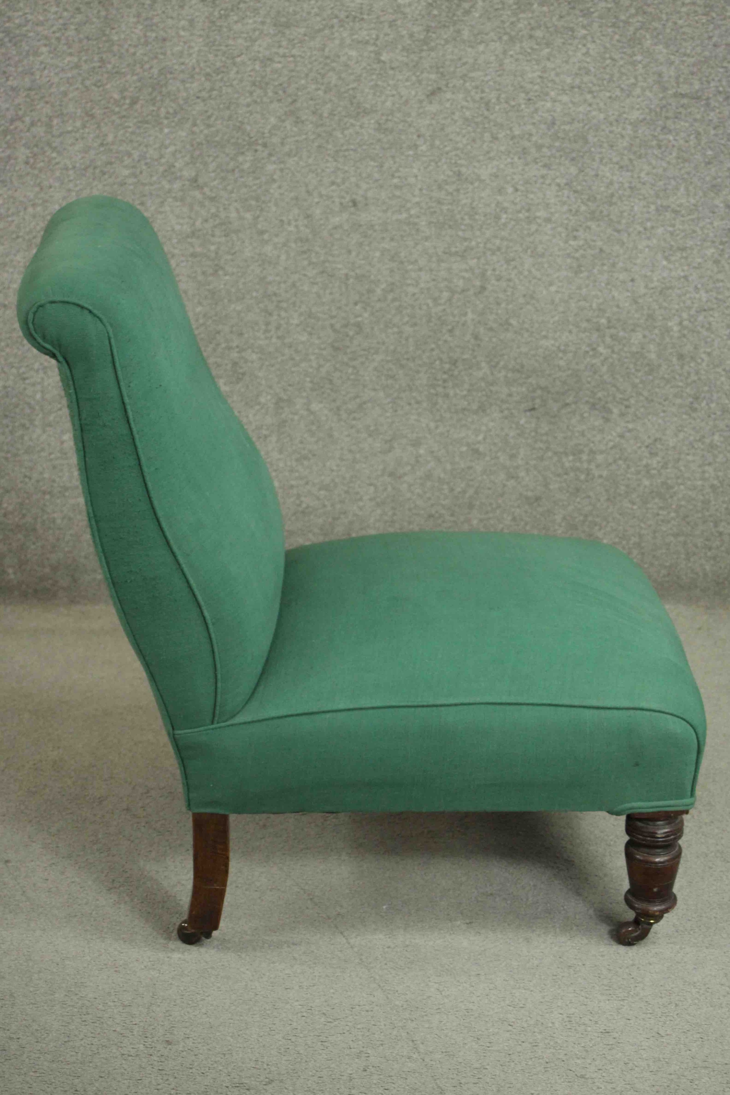 A Victorian mahogany nursing chair, upholstered in green fabric, on ring turned legs. H.85 W.61 D. - Image 3 of 5