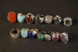 A collection of fourteen gem set and silver rings, set with tiger's eye, ruby, malachite, carnelian,