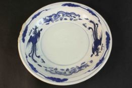 A 20th century Chinese blue and white hand painted porcelain plate decorated with dragons and