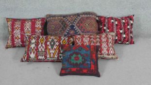 A collection of six Persian carpet cushions. L.36 W.58cm.