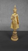 An early 20th century gilded bronze figure of Buddha on a hexagonal base. H.45 W.11cm.