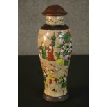 A Chinese early 20th century hand painted crackle glaze vase with turned lid. Decorated with