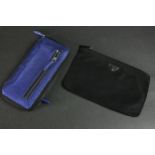 A vintage black silk Prada zip purse along with a Philip Lim metallic blue leather clutch bag. H.