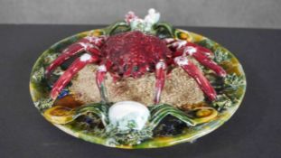 A Palissy style majolica spider crab plate, decorated with moulded sea shells to the border and sand