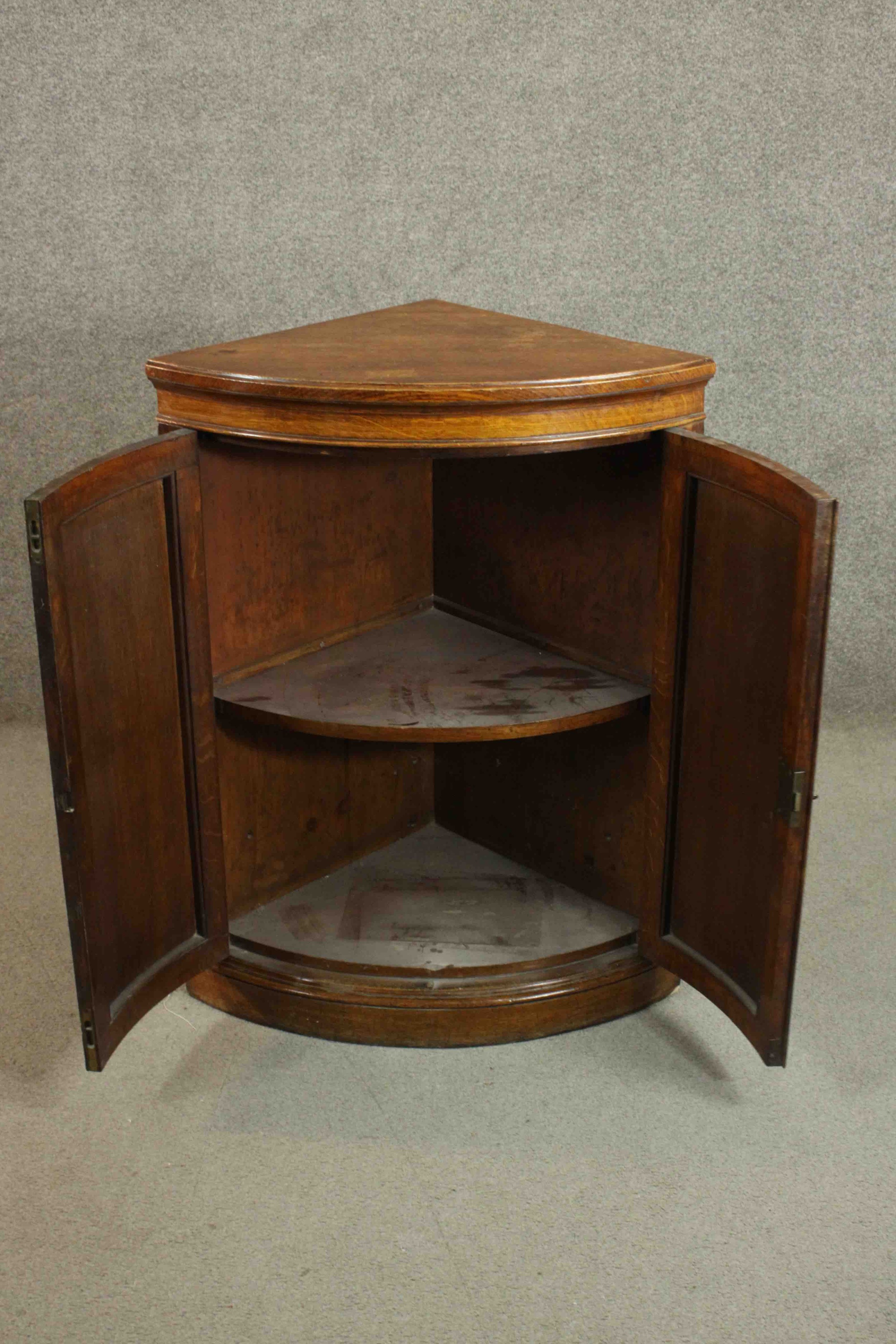 A 19th century oak bow fronted corner cabinet, with two doors opening to reveal a shelf on a - Image 4 of 7