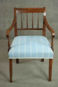 A Regency elm and fruitwood bar back open armchair, the arms with turned vase supports,