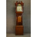 A George III mahogany and oak longcase clock, the hood with a swan neck pediment, the enamelled dial