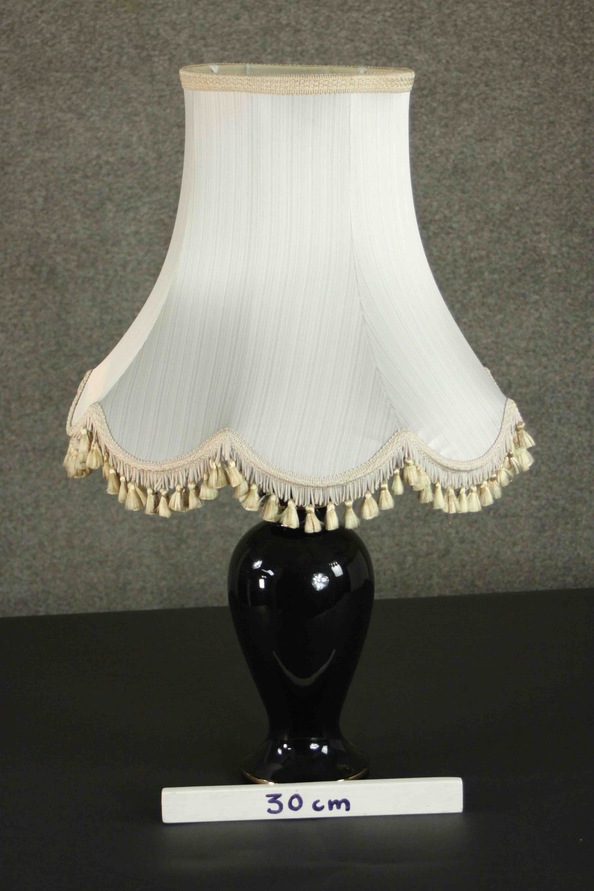 A late 20th century black glazed ceramic baluster form table lamp, with a cream coloured shade. H.75 - Image 2 of 4