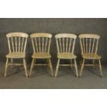 A set of four late 20th century oak kitchen chairs, with a bar back over turned spindles above a
