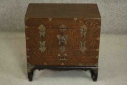 A small Chinese or Korean elm chest on stand, with brass mounts, fitted with two doors. H.40 W.56