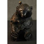 A Black Forest carved seated bear and cub. H.27 W.16 D.15cm.