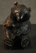 A Black Forest carved seated bear and cub. H.27 W.16 D.15cm.
