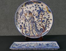 A FCA Sant'Anna Portuguese hand painted ceramic charger with a lady and a bird in the garden along