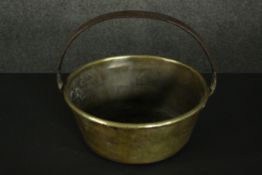 A large Victorian brass preserve pan with an iron swing handle. H.26 Dia.29cm.