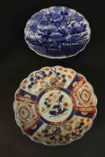 Two 19th century scalloped edged Japanese ceramic plates. One Imari style with stylised flowers