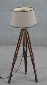 A vintage style tripod form standard lamp, with adjustable legs and brass mounts, with a shade. H.