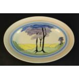 A Clarice Cliff Bizarre cream oval platter, later painted with Art Deco style tree motif. L.42 W.