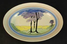 A Clarice Cliff Bizarre cream oval platter, later painted with Art Deco style tree motif. L.42 W.