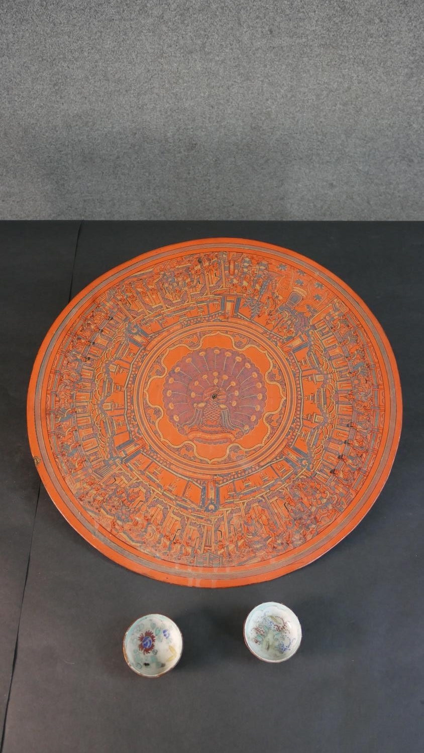 A 19th century engraved lacquer mandala, decorated with figures of Buddha and a peacock to the