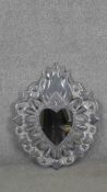 A large vintage repousse tin Mexican flaming heart wall mirror. H.80 W.64cm.