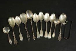 A collection of twelve silver and white metal spoons and a pair of 19th century silver sugar