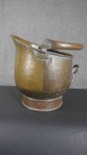 A Victorian planished copper coal bucket with a swing handle. H.37 D.37cm.