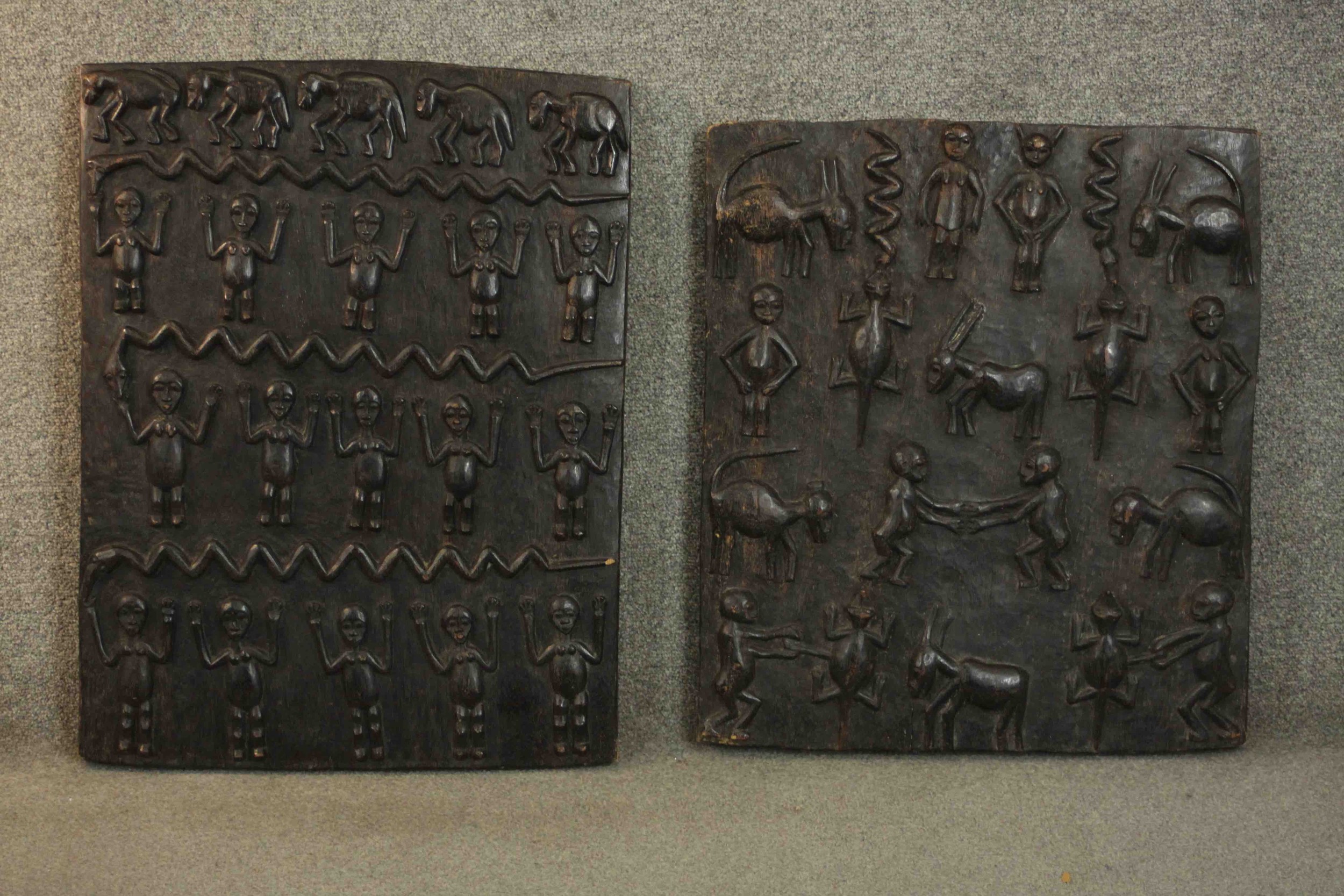 Two early 20th century African tribal carved panels depicting animals and figures. H.70 W.50cm.(