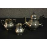 An Art Deco three piece silver tea set by Thomas Bradbury & Sons Ltd. The tea set with angular