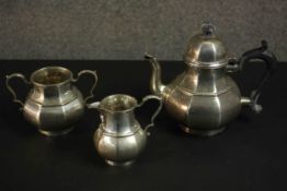 An Art Deco three piece silver tea set by Thomas Bradbury & Sons Ltd. The tea set with angular