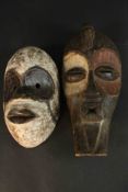 Two carved and painted early 20th century tribal African masks. H.50 W.23 D.17cm