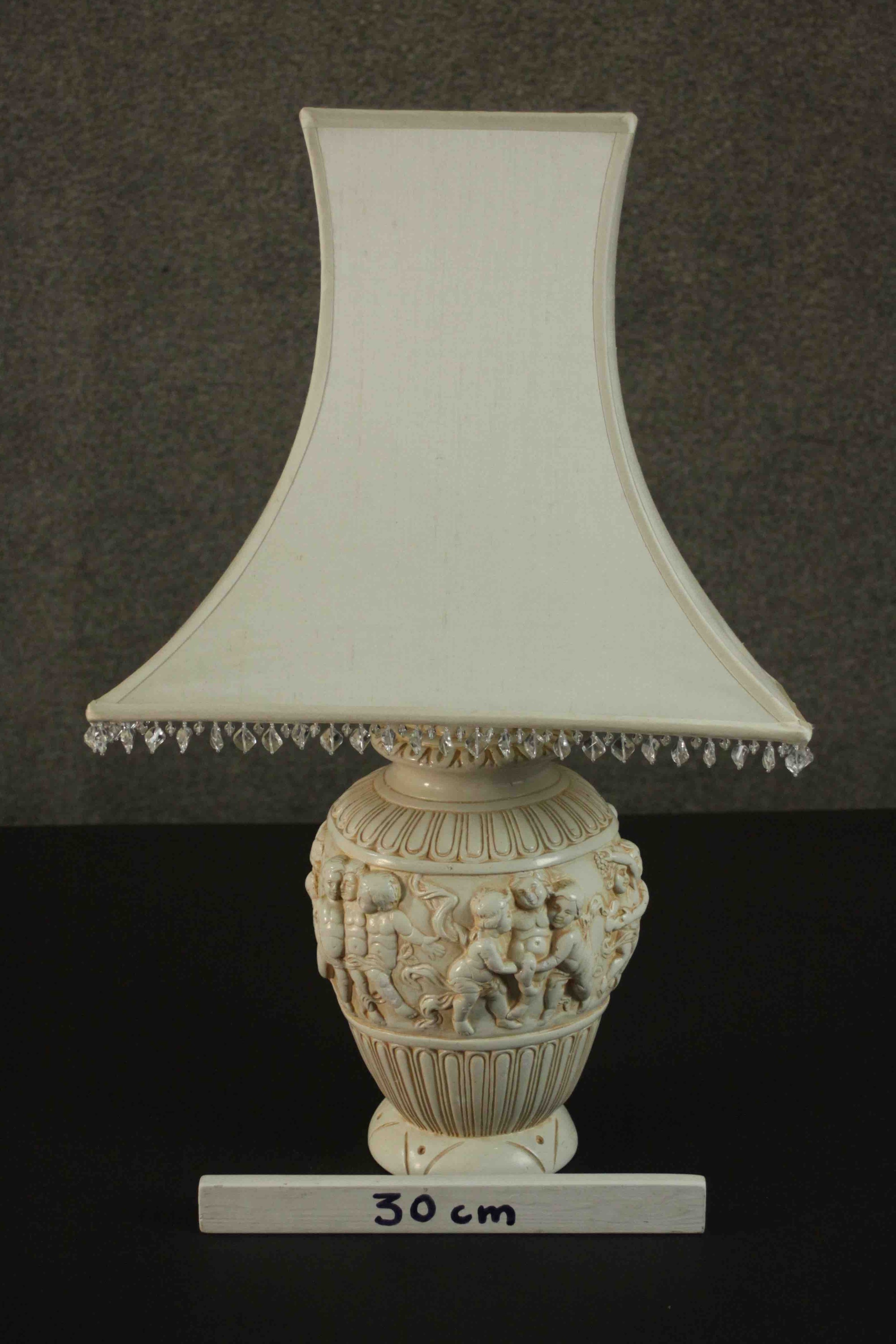 An ivory coloured resin table lamp, cast with a Bacchanalian scene, with a shade. H.67 W.40cm. - Image 2 of 4