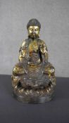 A 20th century gilded bronze Buddha in lotus position on a lotus flower form base. H.30 W.18 D.15cm.