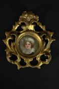 A pierced and carved giltwood framed hand painted miniature portrait on porcelain of a young lady,