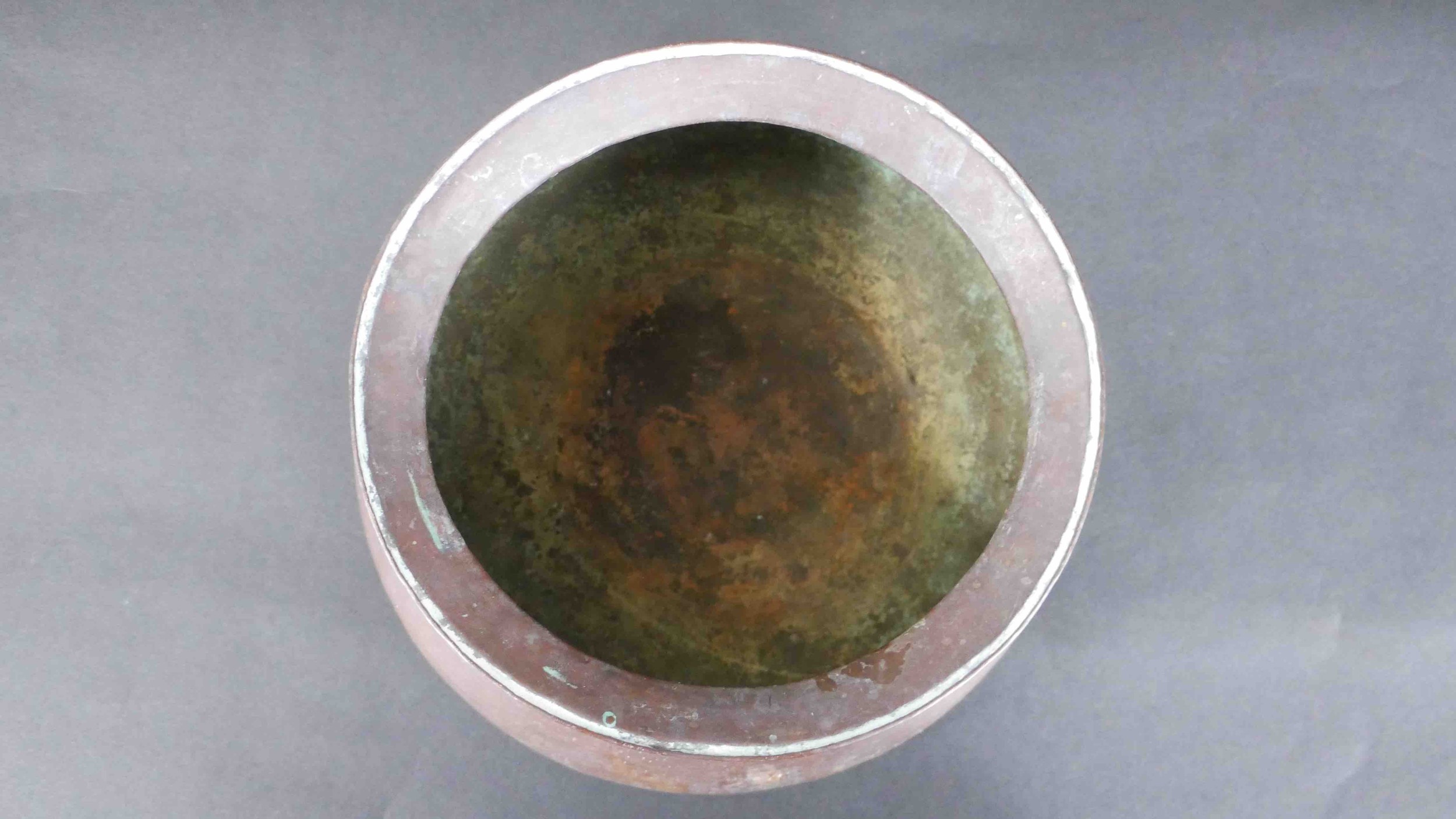 Two early 20th century Indian hammered copper lipped water bowls along with two swing handled - Image 4 of 4