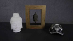 A carved white marble Buddha head along with a Tibetan Kapala resin tortoiseshell form mask with