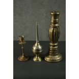 Three Indian brass items, comprising an ornately decorated candlestick, another candlestick, and a
