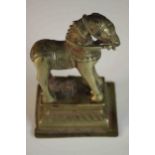 A 19th century Indian brass horse with relief detailing on a ridged rectangular base. H.14 W.9 D.