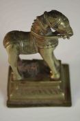 A 19th century Indian brass horse with relief detailing on a ridged rectangular base. H.14 W.9 D.